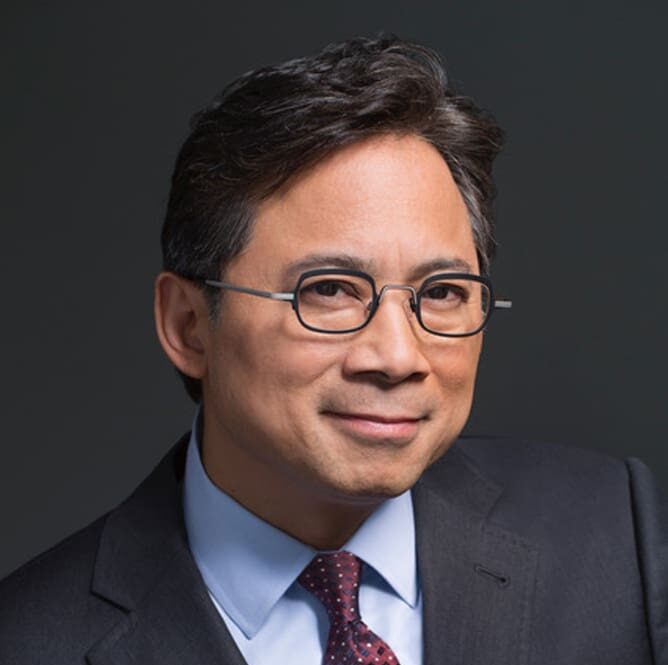 Professional photo of Dr. William Li, expert on anti-inflammatory foods, in suit and tie